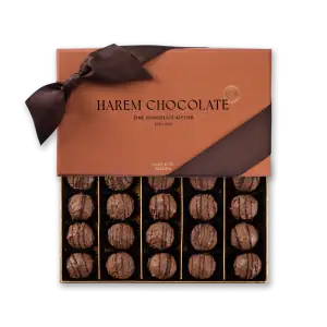 Luxurious box of Turkish-style chocolate truffles with rich chocolate drizzle, elegantly presented in a brown gift box with a ribbon, perfect for gifting or indulgence.