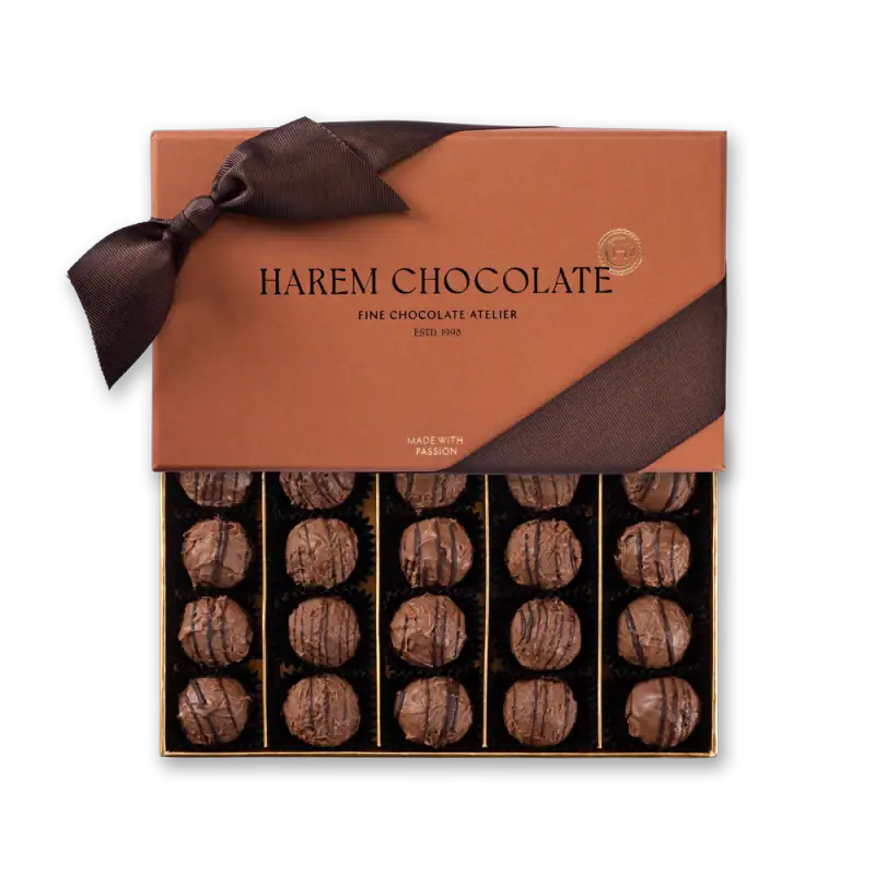 Luxurious box of Turkish-style chocolate truffles with rich chocolate drizzle, elegantly presented in a brown gift box with a ribbon, perfect for gifting or indulgence.