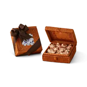 Miniature woven basket gift box with a dark brown ribbon and a decorative tag, filled with wrapped Turkish candies. Perfect for gifting or souvenirs.