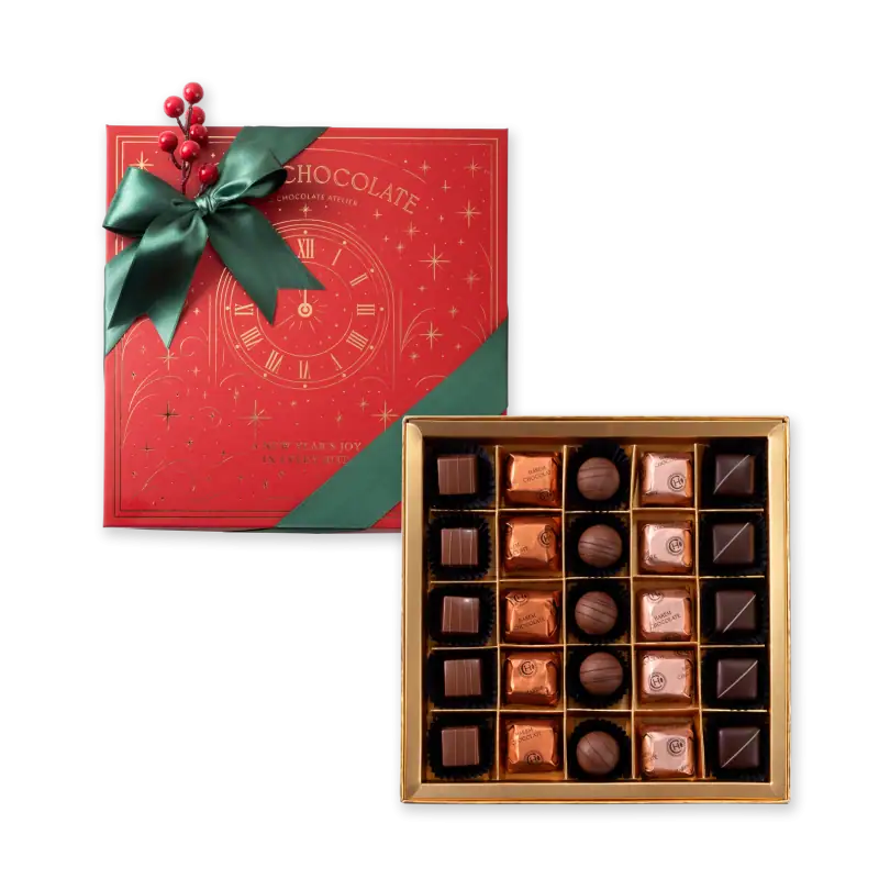 Luxurious box of assorted chocolates with a festive holiday gift box featuring a clock and green ribbon, perfect for celebrating Christmas and New Year with fast shipping from Turkey.