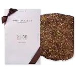 1. Luxurious Turkish slab chocolate coated with mixed seeds and nuts, presented with elegant white packaging and a brown ribbon, perfect for gifting or indulgence.
