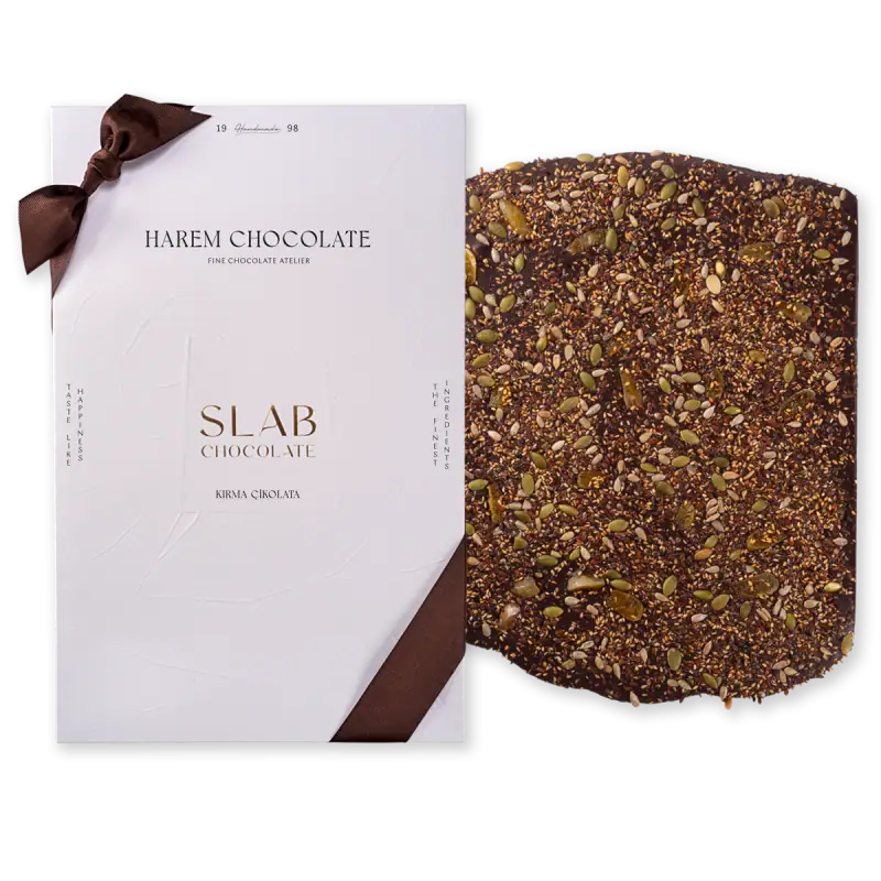 1. Luxurious Turkish slab chocolate coated with mixed seeds and nuts, presented with elegant white packaging and a brown ribbon, perfect for gifting or indulgence.