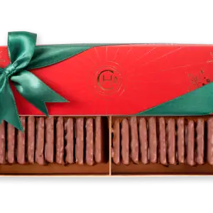 Delicious chocolate-covered biscuits in festive holiday packaging with a green ribbon, perfect for Christmas gifts or celebrations.