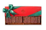 Luxurious Turkish chocolate sticks in a festive red gift box with green ribbon for holiday celebrations. Perfect for gifting or enjoying during special occasions.