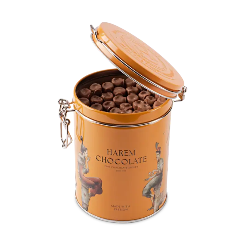 Smooth milk chocolates in an orange tin container, featuring traditional Turkish artwork, perfect for gifting or indulging your sweet cravings from Turkey.
