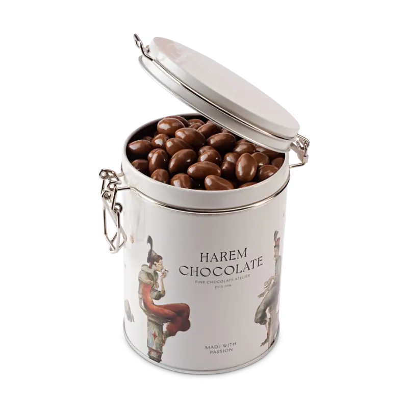 Rich Turkish chocolate candies inside a white decorative tin container with artistic illustrations and "Harem Chocolate" branding from Turkey, ideal for gift-giving or snacking.