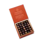 Assorted luxury Turkish chocolates in a rich orange gift box with gold accents, perfect for gifting or indulging. Fast shipping from Turkey available at Shop of Turkey.