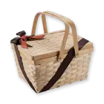 Natural woven picnic basket with handle, brown and orange ribbon decoration, perfect for outdoor outings and storage.