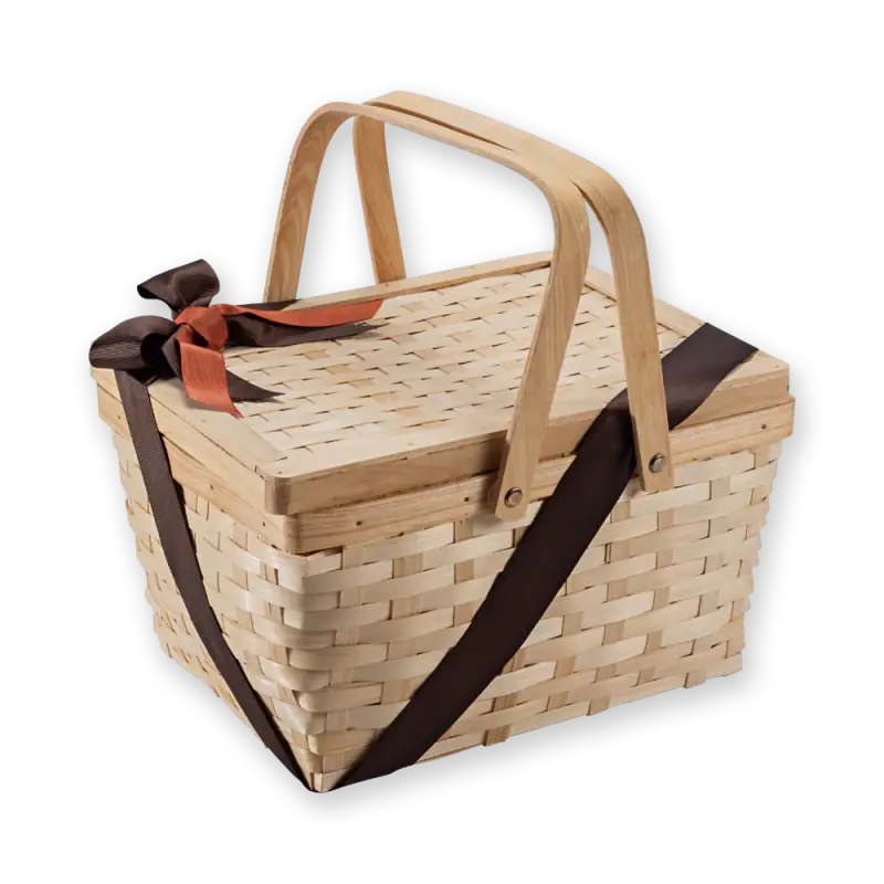Natural woven picnic basket with handle, brown and orange ribbon decoration, perfect for outdoor outings and storage.