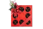 Delicious assorted chocolates in a festive red gift box with a satin ribbon and holiday decorations, perfect for seasonal gifting from Turkey.