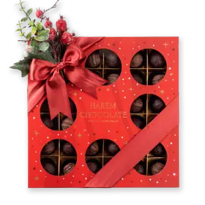 Delicious assorted chocolates in a festive red gift box with a satin ribbon and holiday decorations, perfect for seasonal gifting from Turkey.