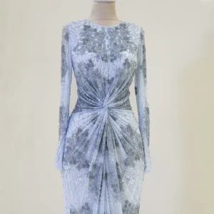 Elegant silver evening gown with intricate beadwork and a draped design, perfect for formal occasions and special events.