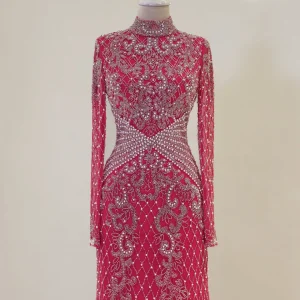 Elegant pink evening gown with intricate silver embellishments and sheer long sleeves, displayed on a mannequin at Shop of Turkey. Perfect for special occasions and formal events.