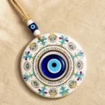 Mandala evil eye disc showing turquoise gold purple folk motifs in detail