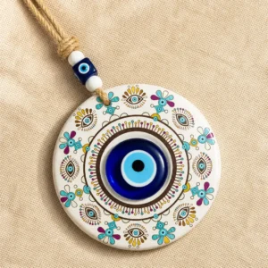 Mandala evil eye disc showing turquoise gold purple folk motifs in detail
