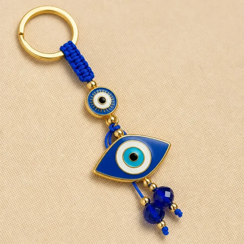 Turkish evil eye keychain laid flat on a neutral surface with beads spread