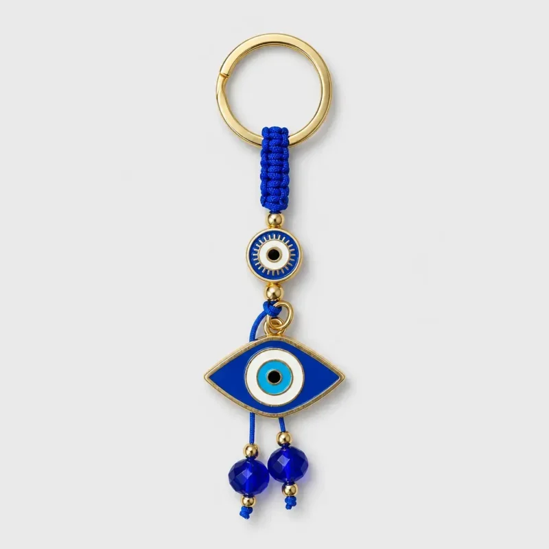 Turkish evil eye keychain with blue macramé cord held in palm