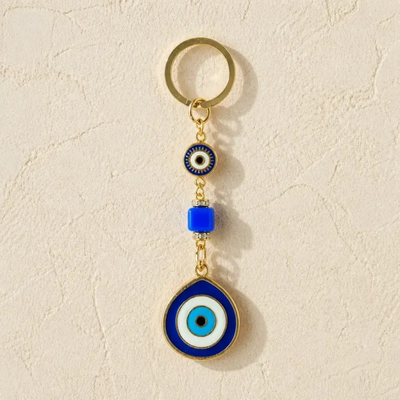 Evil eye keychain held in hand showing scale and blue nazar detail
