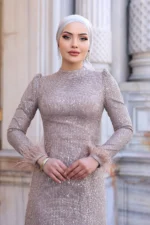 Glimette hijab evening dress in champagne sequin with feather-trimmed cuffs and high neckline