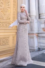 Glimette hijab evening dress in champagne sequin with feather-trimmed shimmer tulle cuffs, full length