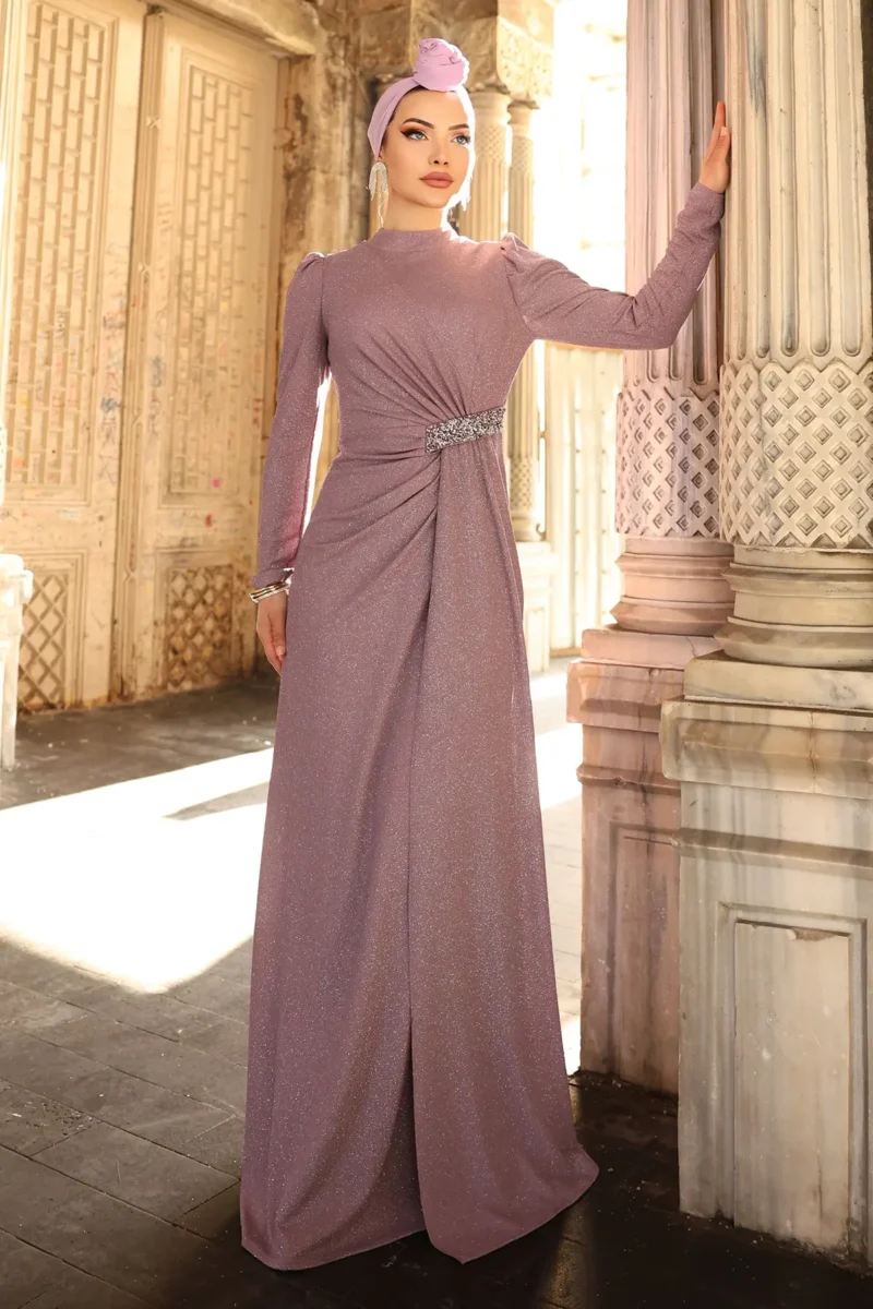 Glimmette hijab evening dress in dusty pink with glitter fabric, ruched waist, and stone-embellished belt detail