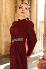 Glimmette hijab evening dress in burgundy with glitter fabric, puff sleeves, and stone-embellished waist belt
