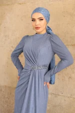 Blue glitter hijab evening dress with stone-embellished waist belt and puff sleeves worn with matching hijab