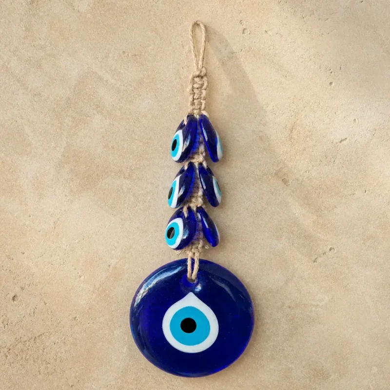 Deep blue nazar wall hanging held up in a home interior setting