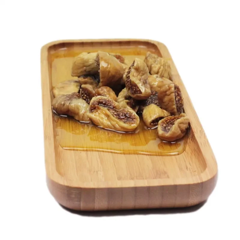 Tuğba Kuruyemiş olive oil fig cure served on a wooden tray with syrup